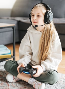 Little girl playing on games console photo