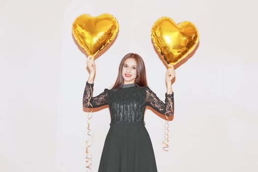 woman holds heart shaped golden air balloons. valentines day, birthday, womens day, anniversary, holiday celebration concept photo