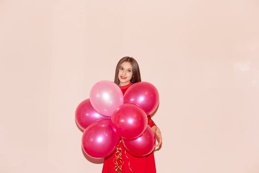attractive and young woman holds balloons. valentines day, birthday, womens day, anniversary, holiday celebration concept photo