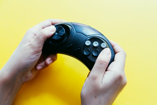 Hand holding game joystick. Gamer playing game photo