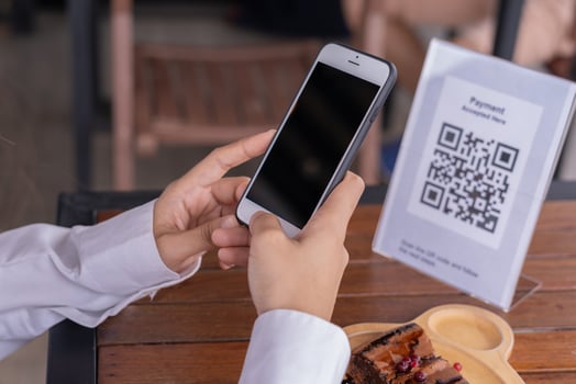 use smartphone to scan QR code for order menu in cafe restaurant with a digital delivery. Choose menu and order accumulate discount. E wallet, technology, pay online, credit card, bank app. photo