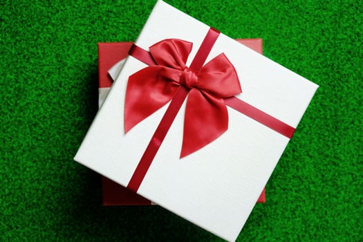 Happy New Year present. Gift box and red ribbon for Christmas. photo