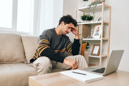 Man student computer laptop modern home cheerful freelance couch online working business comfortable smile photo