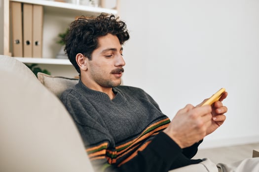Message man technology sofa freelance cellphone typing phone communication lifestyle home photo