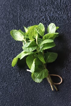 Bunch of fresh mint on the dark background photo