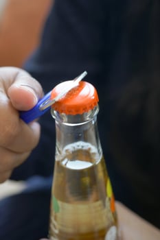 Metal cap and opener on the glass bottle photo