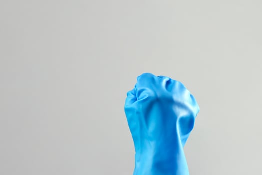 Hands in protective rubber gloves. Fist of housekeeper maid photo