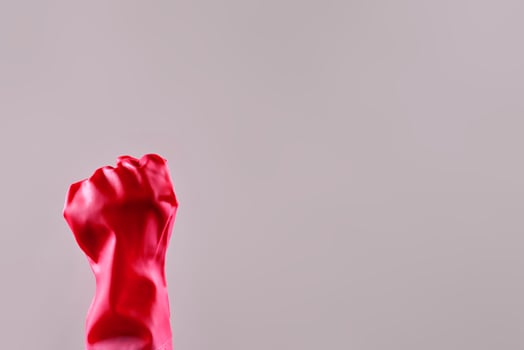 Hands in protective rubber gloves. Fist of housekeeper maid photo
