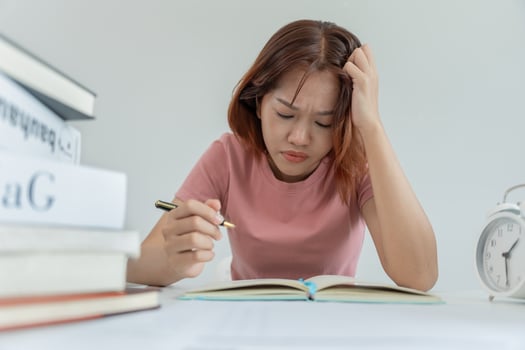 Asian student woman have anxiety because of exams, female prepare for test and learning lessons in the library. stress, despair, haste, misunderstanding reading, discouraged, expectation, knowledge photo
