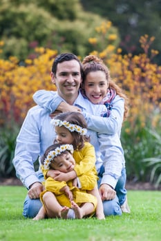 Family of four having fun outdoors in a beautiful sunny day at the park. Happiness concept. Family concept. photo