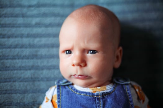 Funny baby 3 months old with a serious face photo