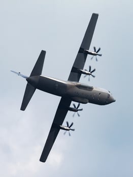 Untitled military transport plane at air base. Airport and airfield. Air force and army flight operation. Aviation and aircraft. Air lift. Military industry. Fly and flying. photo