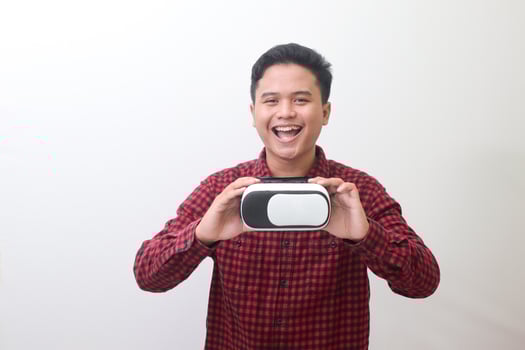 Portrait of Asian man in red plaid shirt getting ready and using Virtual Reality VR. Isolated image with copy space on white background photo