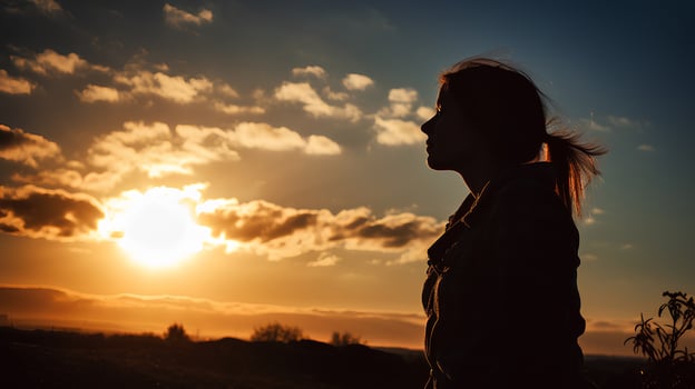 Silhouette of a tired and stressed woman against the sky, sun photo