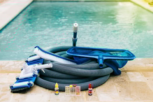 Pool cleaning and maintenance tools, image of pool cleaning and maintenance kit, vacuum cleaner, ph test, leaf picker and pool sweeper photo