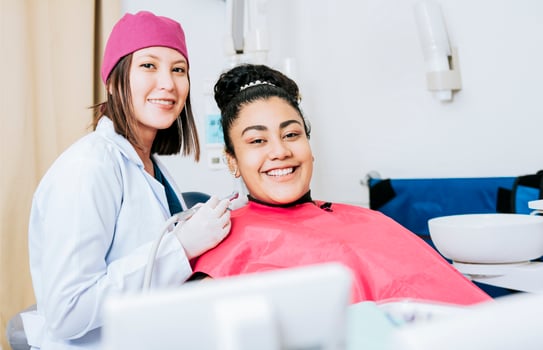 Portrait of smiling dentist with female patient in medical office, Female dentist with smiling female patient looking at camera, Professional dentist with female patient in office photo