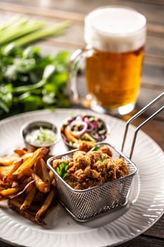 Fried chicken nuggets with french fries, dip, salad and beer photo