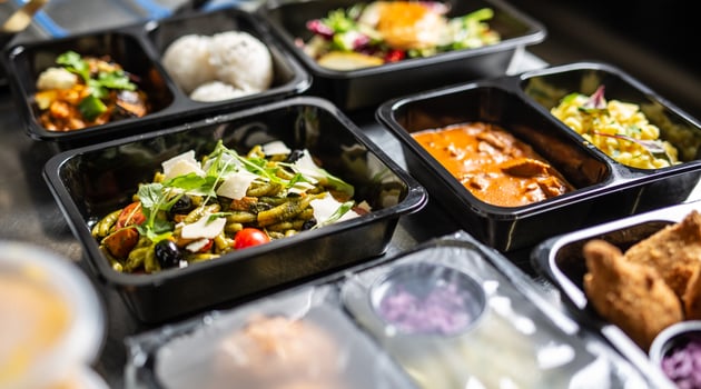 Open and closed plastic disposable takeaway containers with various food ready for deliveries as takeaways surge in coronavirus pandemic photo