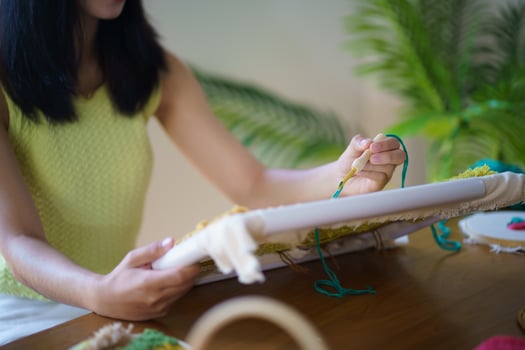 Punch needle. Asian Woman making handmade Hobby knitting in studio workshop. designer workplace Handmade craft project DIY embroidery concept. photo