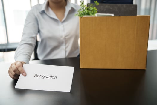 Business woman sending resignation letter to boss and Holding Stuff Resign Depress or carrying cardboard box by desk in office photo