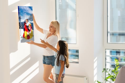 family holds holds photo canvas at home