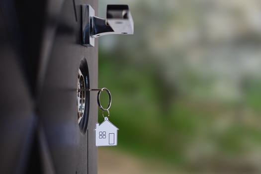 A key in a lock with house icon on it photo