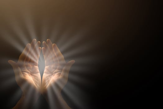 Light in the human hands in the dark photo