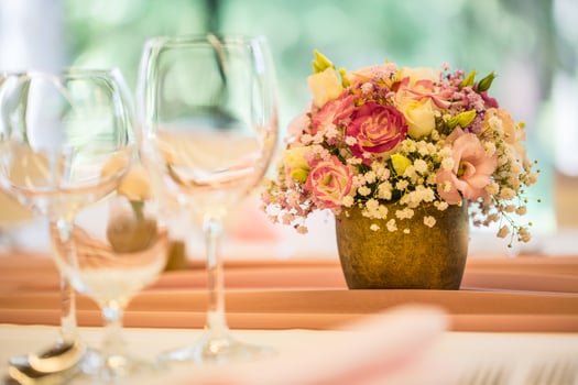 Wedding table setting. Beautiful table set with flowers and glass cups  for some festive event, party or wedding reception photo