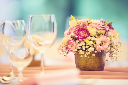 Wedding table setting. Beautiful table set with flowers and glass cups  for some festive event, party or wedding reception photo