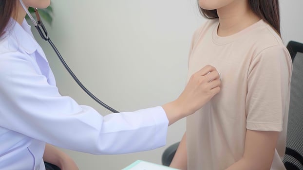 Close up hand woman doctor examining young woman in a hospital. photo