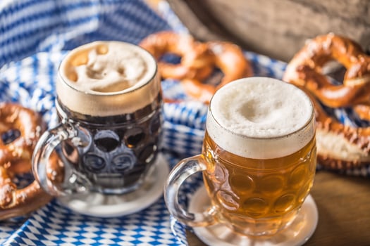 Oktoberfest two beer with pretzel wooden barrel and blue tablecloth photo