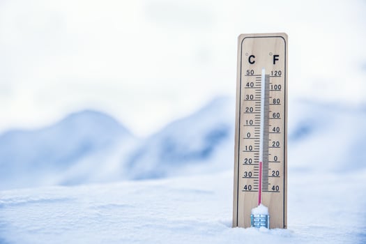 Thermometer on the mountains in the snow shows temperatures below zero. Low temperatures in degrees Celsius and fahrenheit photo