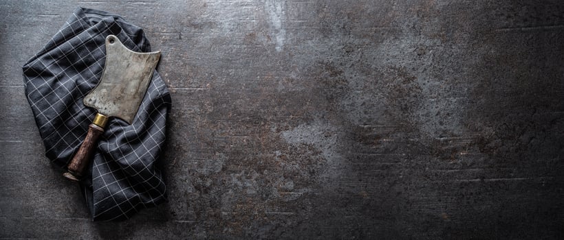 Old meat butcher on dark concrete board - top of view photo