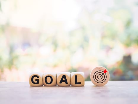 Wooden blocks with the word GOAL and business strategy icons for success and winner concept photo