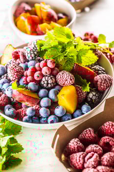 Frozen fruits blueberries blackberry raspberry red currant peach and herbs melissa photo