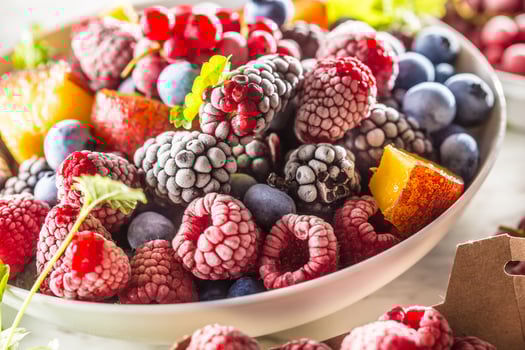 Frozen fruits blueberries blackberry raspberry red currant peach and herbs melissa photo