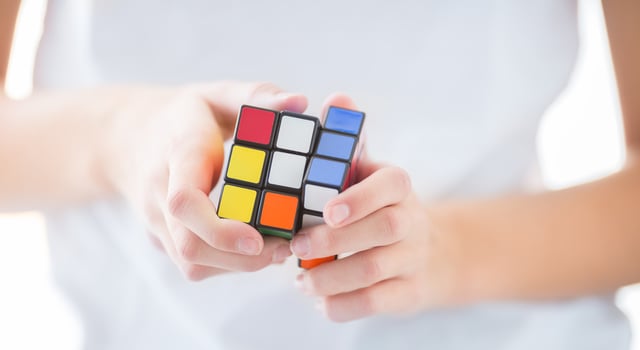 Rubiks Cube in hand young teenage girl photo