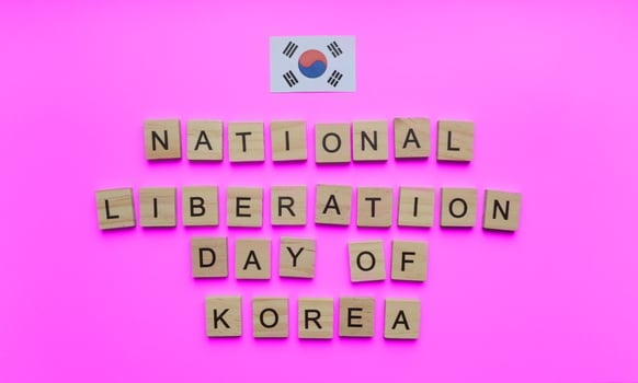 August 15, National Liberation Day of Korea, the flag of Korea, a minimalistic banner with the inscription in wooden letters photo