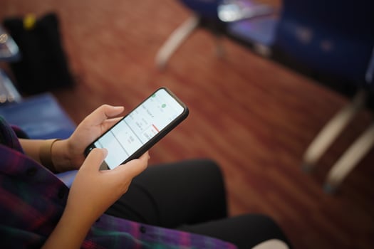 Woman waiting for departure at the airport on your vacation hold passport and smartphone while waiting boarding on departure area International Airport photo