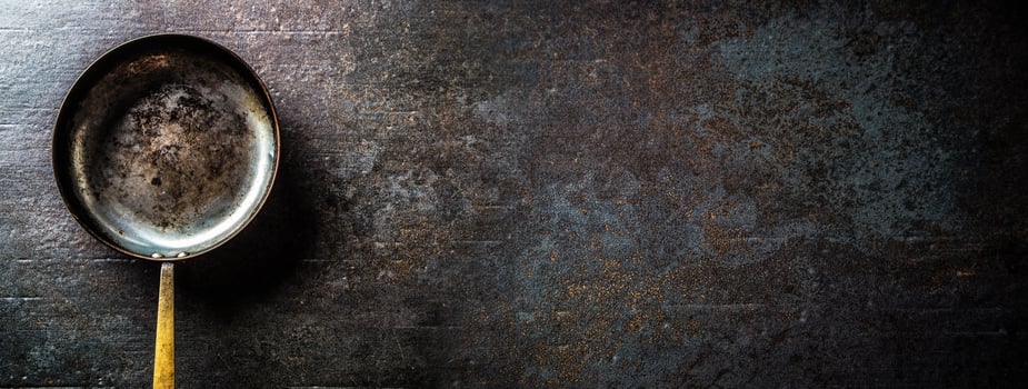 Empty old roast pan on dark concrete board. photo