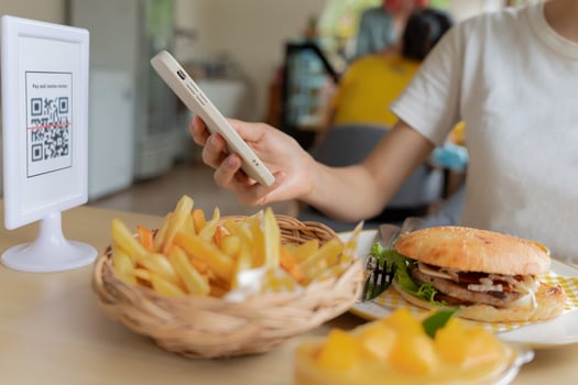 Woman use smartphone to scan QR code for order menu in cafe restaurant with a digital delivery. Choose menu and order accumulate discount. E wallet, technology, pay online, credit card, bank app. photo