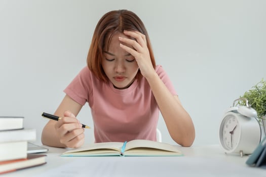 Asian student woman have anxiety because of exams, female prepare for test and learning lessons in the library. stress, despair, haste, misunderstanding reading, discouraged, expectation, knowledge photo