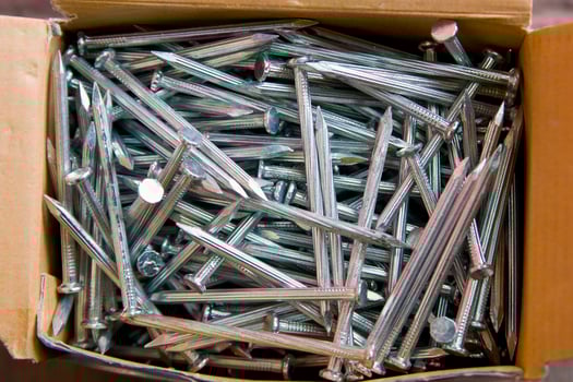 a pile of nails with a variety of sizes photo