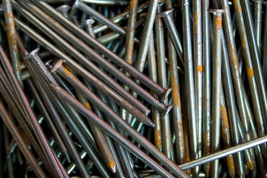 a pile of nails with a variety of sizes photo