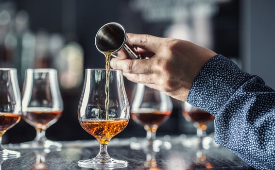Bartender hand pouring alcoholic drink in nightclub, bar or pub. photo