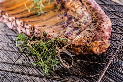 Smoked raw pork ribs and rosemary herbs on wooden board photo