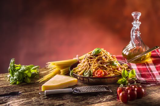Italian pasta spaghetti with tomato sauce olive oil basil and parmesan cheese in old pan photo