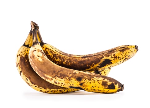 Banana. Over ripe bananas isolated on white with shadows photo