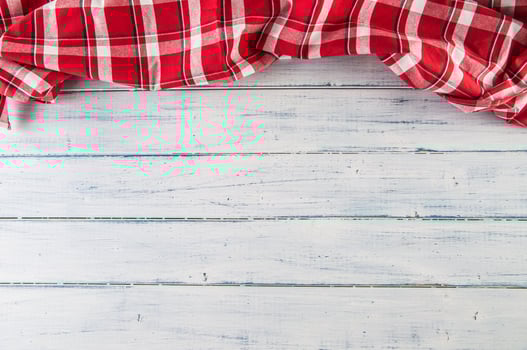 Top of view red checkered tablecloth on wooden table photo