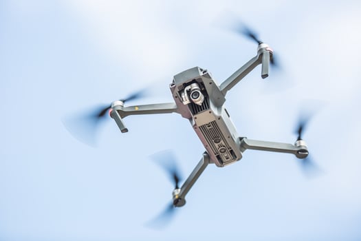 Close-up quadcopter drone with camera flying in park photo